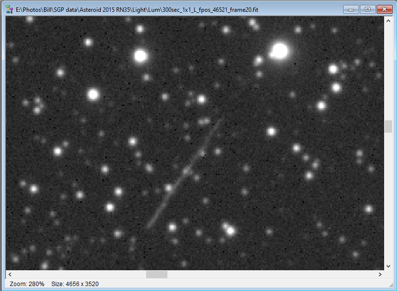 Asteroid moving through a star field